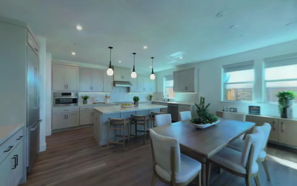 The kitchen of the model house twin, its island under three pendant lights.